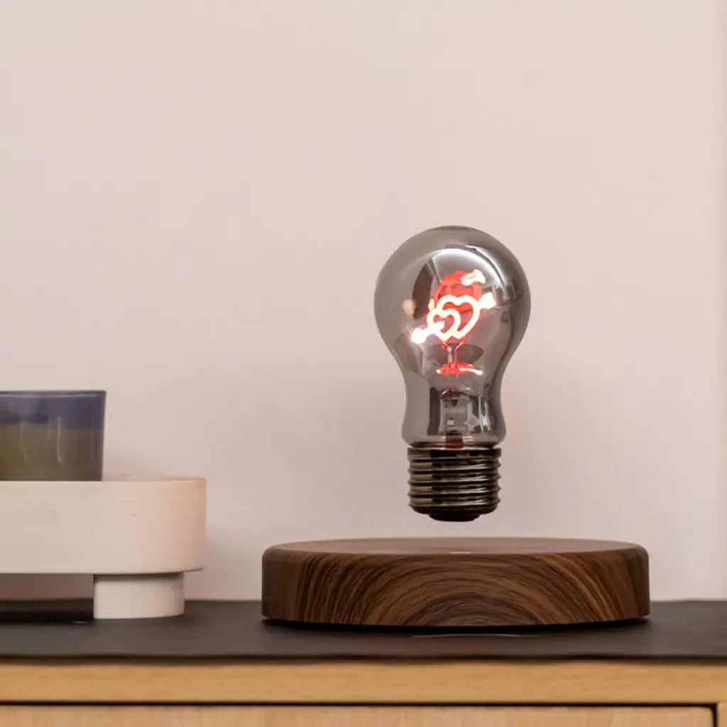 Cupid two heart magnetic levitating light bulb displayed on modern desk