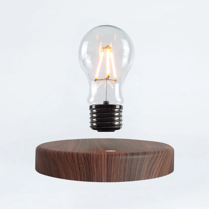Classic light bulb magnetic levitating lamp on wood base, white background