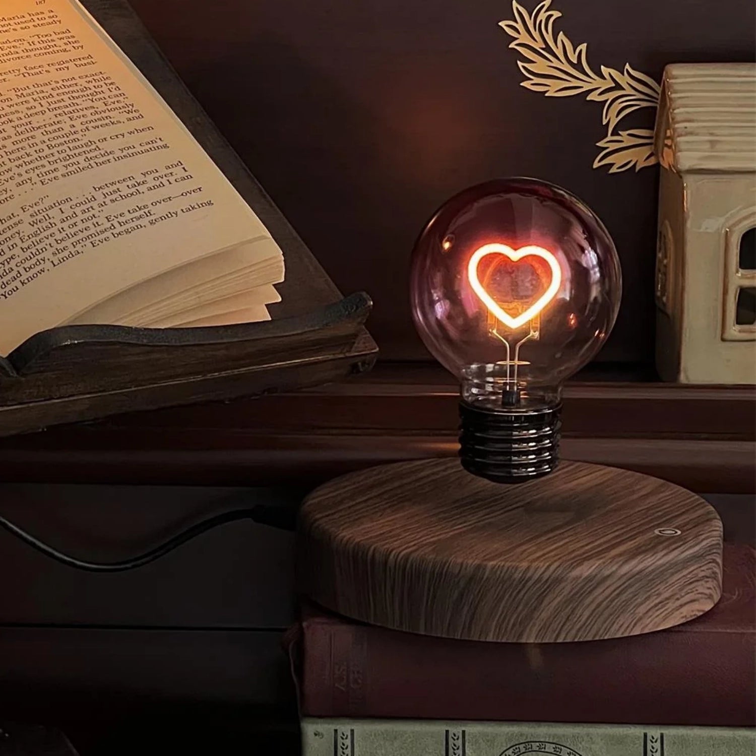 Heart light bulb magnetic levitating lamp glowing on wooden desk