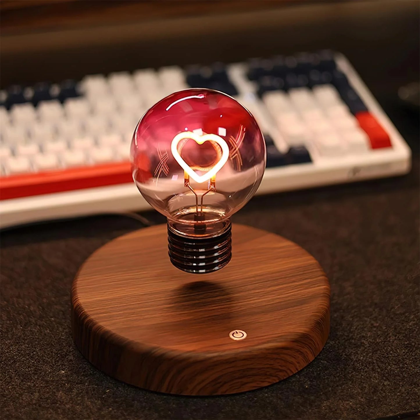 Heart light bulb magnetic levitating lamp with walnut wooden base on gaming desk with keyboard and monitor