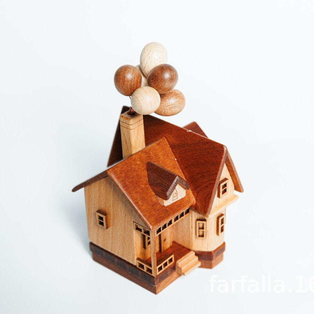Handmade wooden balloon house with natural wood balloons, levitating floating toy desk decor.