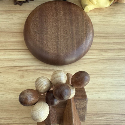 Top down view of the dark walnut magnetic base and the maple wood house components detached.