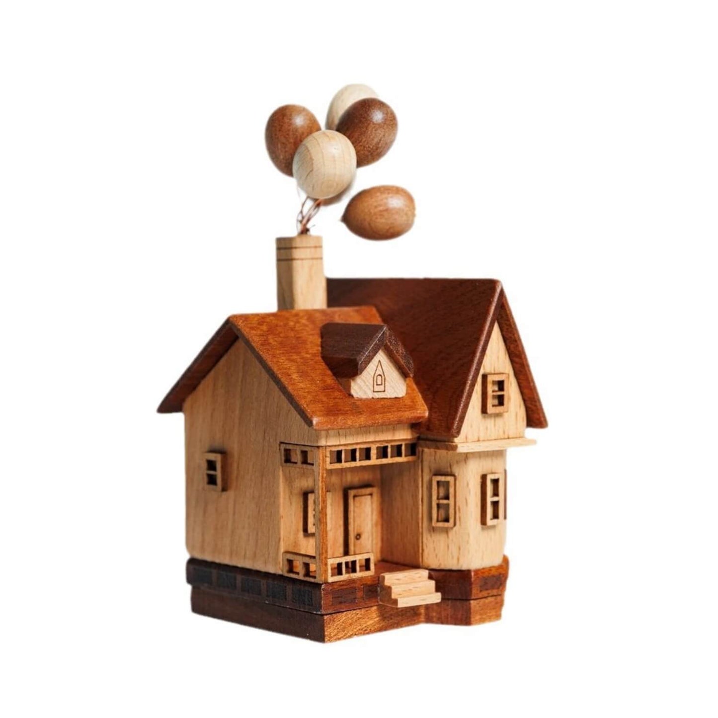 Side view showing the detailed solid wood grain of the flying house sculpture with wooden balloons.